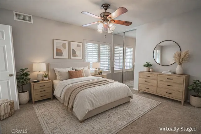 an empty room with windows and fan