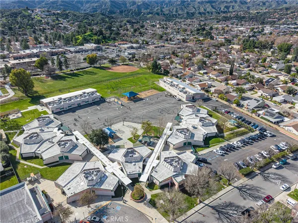 an aerial view of residential building and trees around