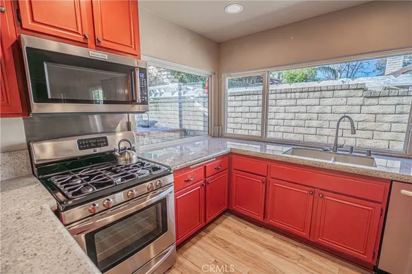 a kitchen with granite countertop a stove and a sink
