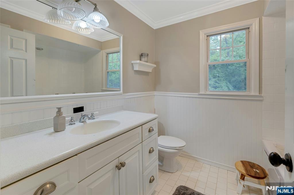 744 River Road Chatham, NJ 07928 - Photo 13 of 19 a bathroom with a granite countertop toilet sink and mirror