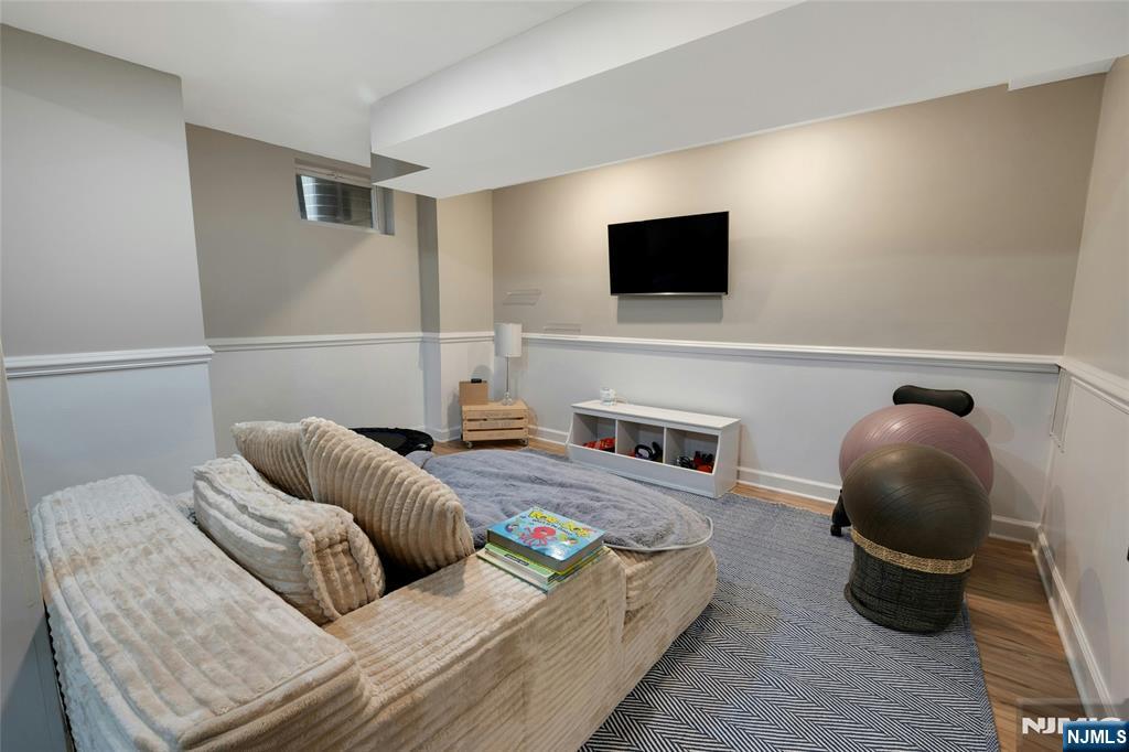 744 River Road Chatham, NJ 07928 - Photo 14 of 19 a living room with furniture and a flat screen tv