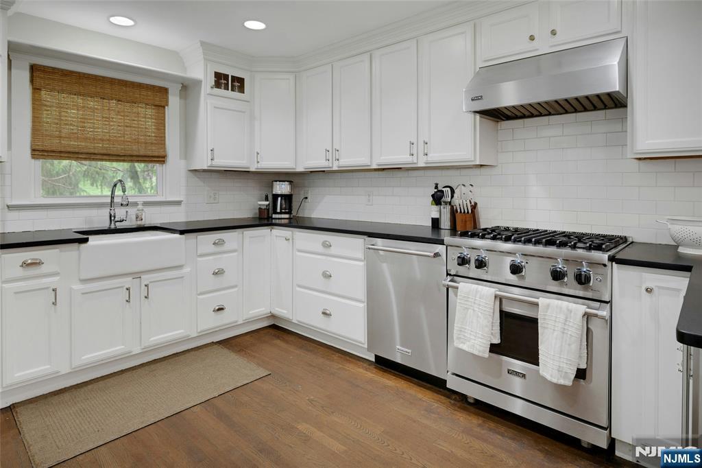 744 River Road Chatham, NJ 07928 - Photo 7 of 19 a kitchen with white cabinets and white appliances