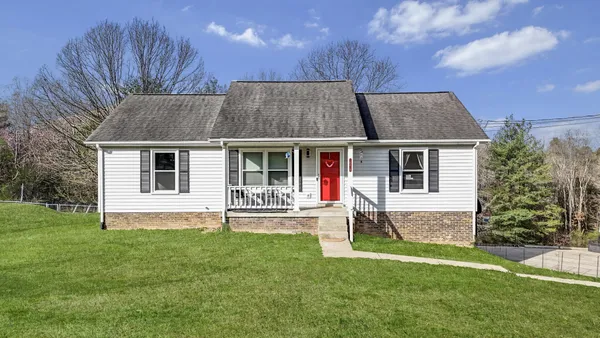 a house view with a sitting space and garden