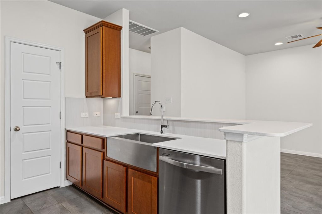 1502 Airedale Road, Unit 2502 Austin, TX 78748 - Photo 12 of 28 A well-appointed kitchen showcasing a deep farmhouse sink and integrated stainless steel appliances.