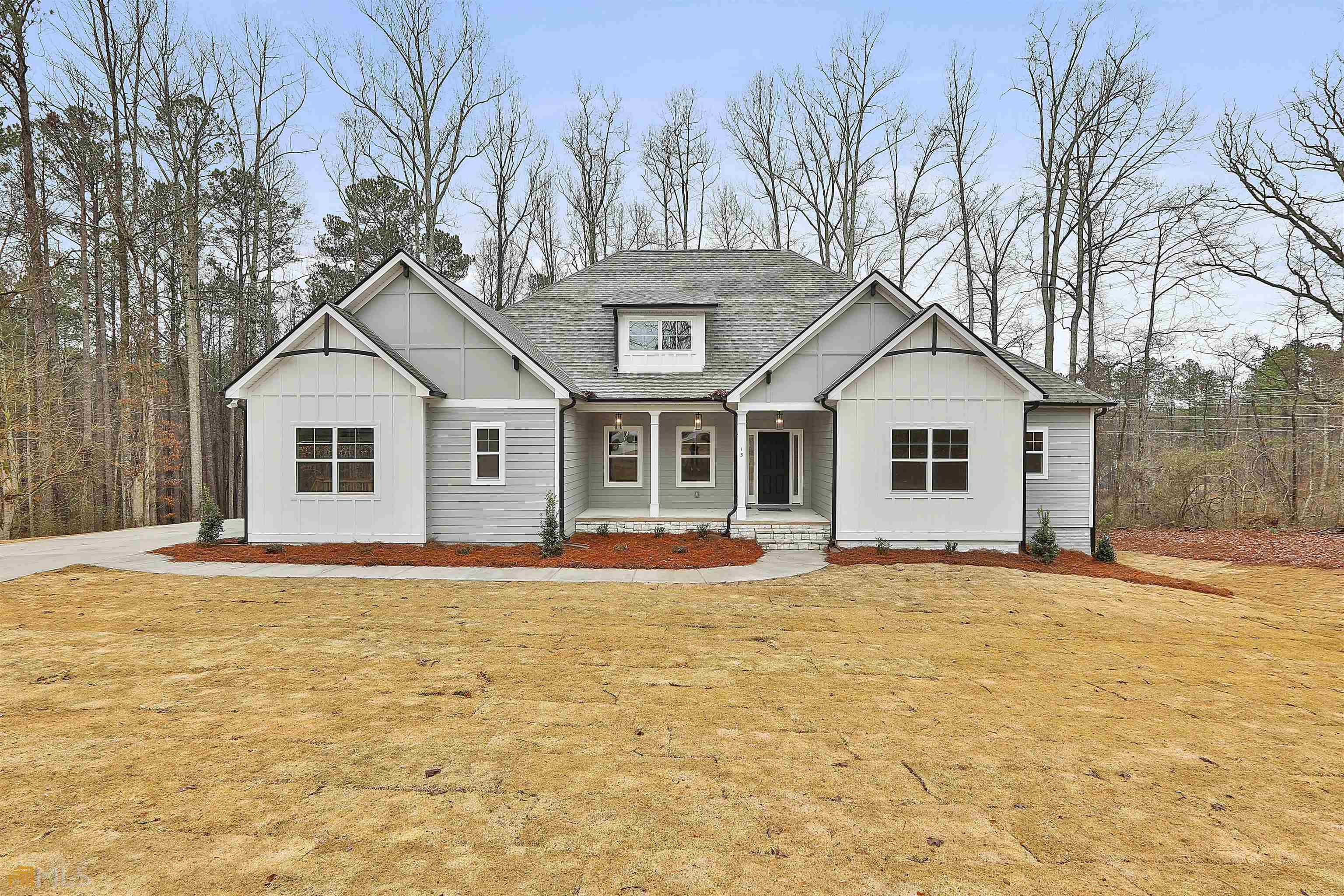 15 Sanders-Davis Road, Unit 16 Newnan, GA 30263 - Photo 1 of 1 a front view of a house with a yard and garage