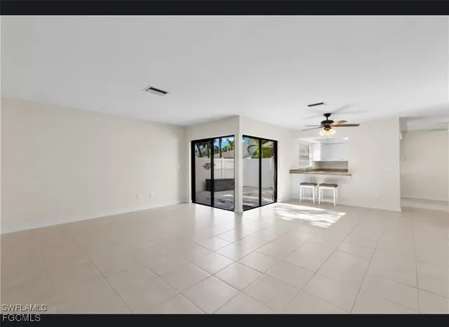 a view of an empty room with a kitchen