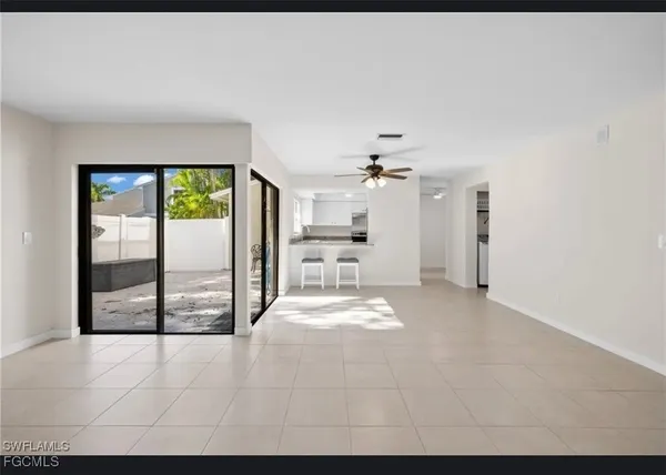 a view of a kitchen with a sink and a large window