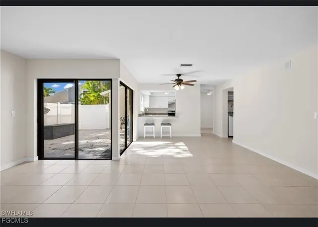 a view of a kitchen with a sink and a large window