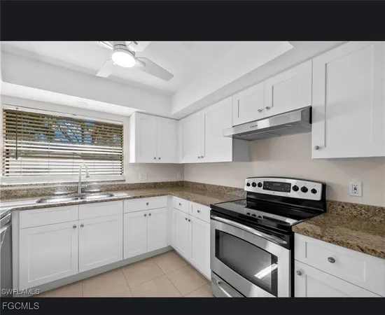 a kitchen with stainless steel appliances granite countertop a sink stove and cabinets
