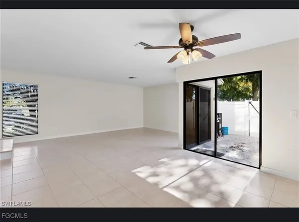 a view of a livingroom with a ceiling fan and window