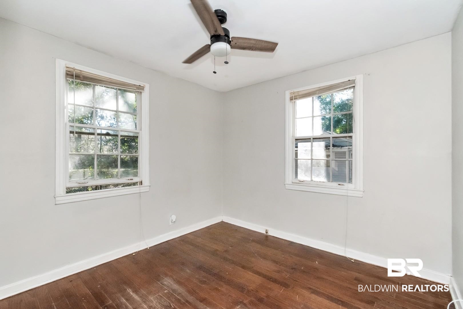 5001 Hillwood Circle South Mobile, AL 36608 - Photo 14 of 20 Empty room featuring dark wood-style flooring, ceiling fan, and baseboards