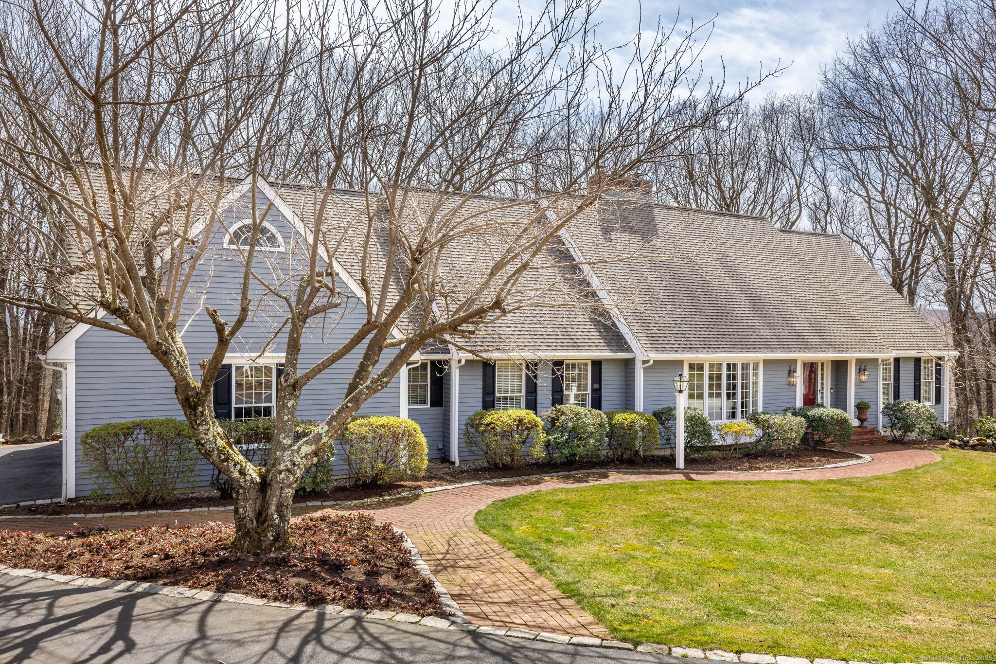 a front view of a house with a yard table and chairs