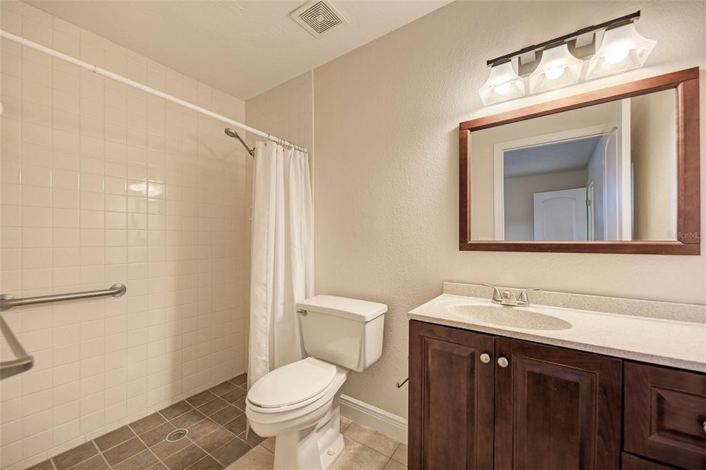 1330 Georgetowne Circle Sarasota, FL 34232 - Photo 30 of 46 a bathroom with a toilet a sink a vanity and mirror