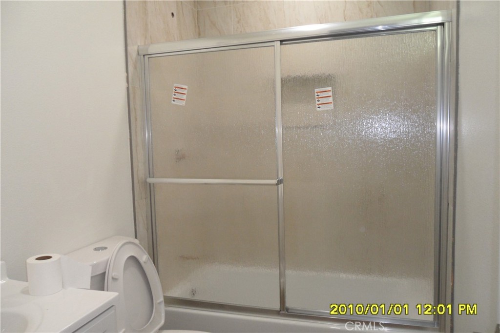 871 Maple Lane Sugarloaf, CA 92386 - Photo 8 of 17 a bathroom with a glass shower door