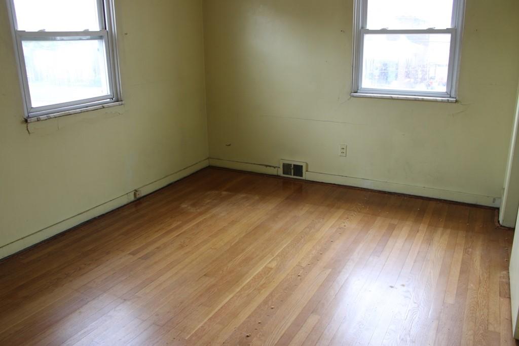 825 Liberty Street Duquesne, PA 15110 - Photo 11 of 25 an empty room with wooden floor and windows