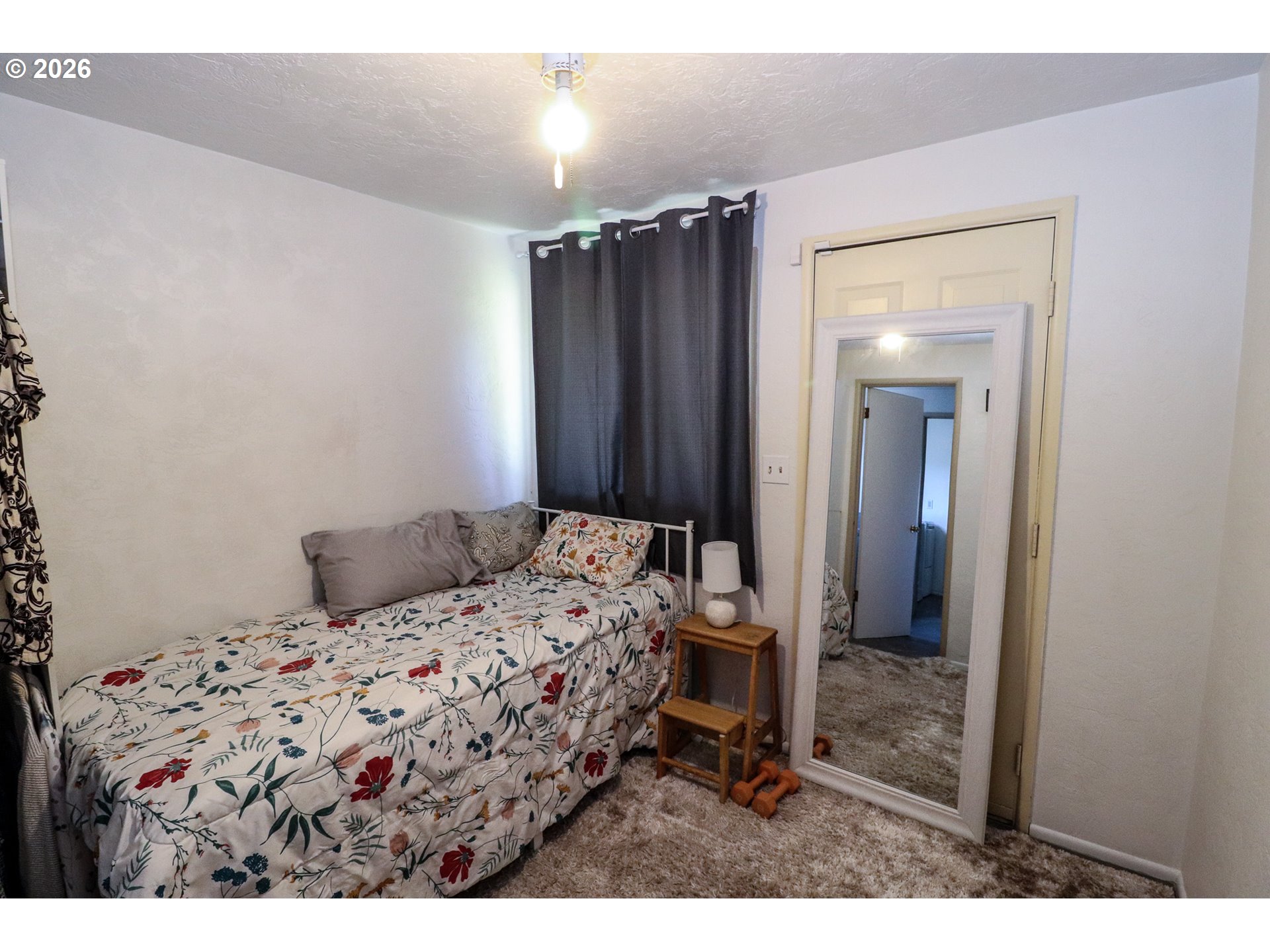 7077 Main Street Springfield, OR 97478 - Photo 25 of 34 a bedroom with a bed and a mirror