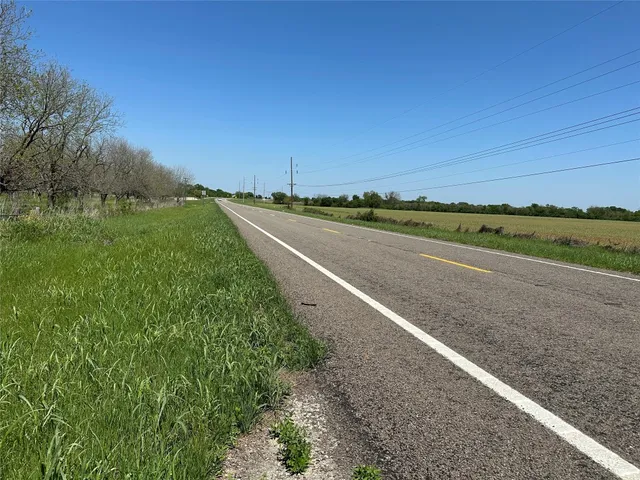 a view of a green field with trees
