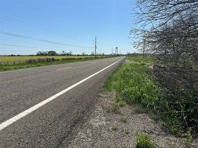 a big yard with lots of green space and bushes