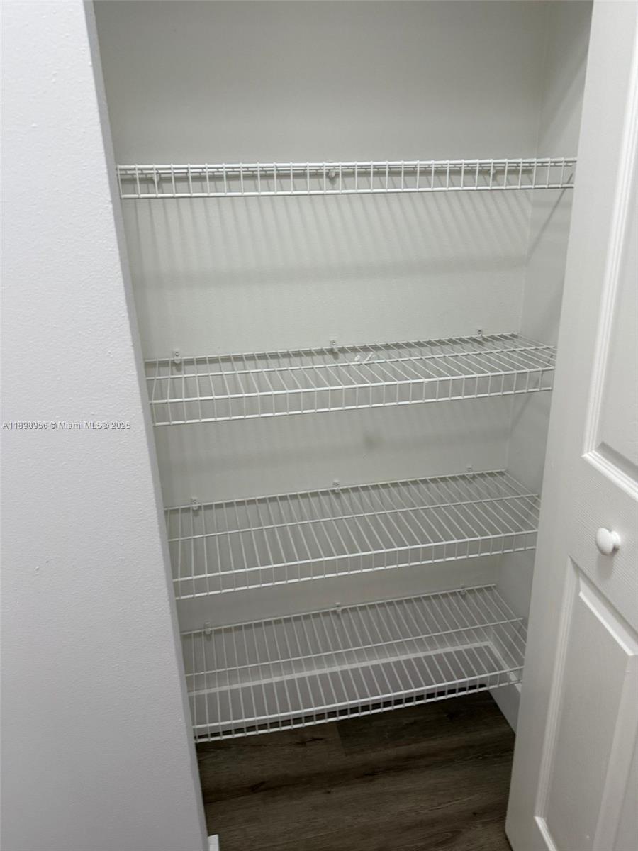 11040 Southwest 196th Street, Unit 211 Cutler Bay, FL 33157 - Photo 10 of 10 a view of staircase with white walls and white door