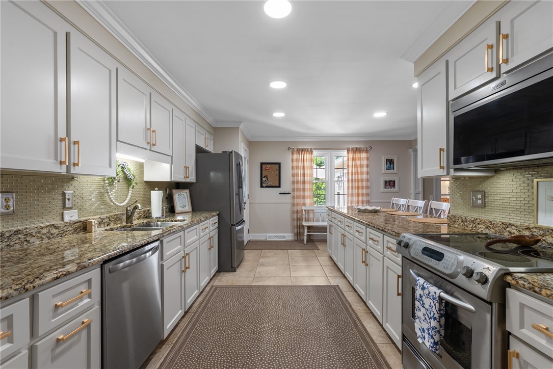3513 Hopewell Road Anderson, SC 29621 - Photo 28 of 50 A well-appointed kitchen features ample white cabinetry and warm granite countertops for culinary pursuits.