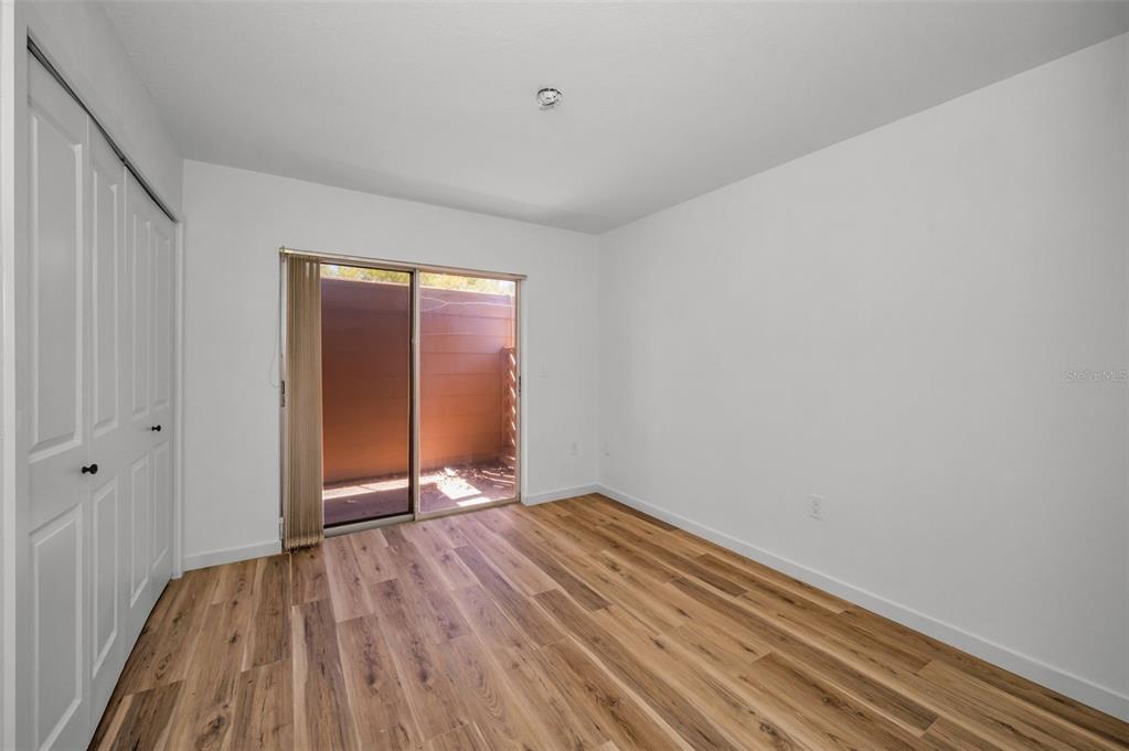 3847 Lighthouse Way, Unit 3847 New Port Richey, FL 34652 - Photo 17 of 89 a view of an empty room with wooden floor and a window