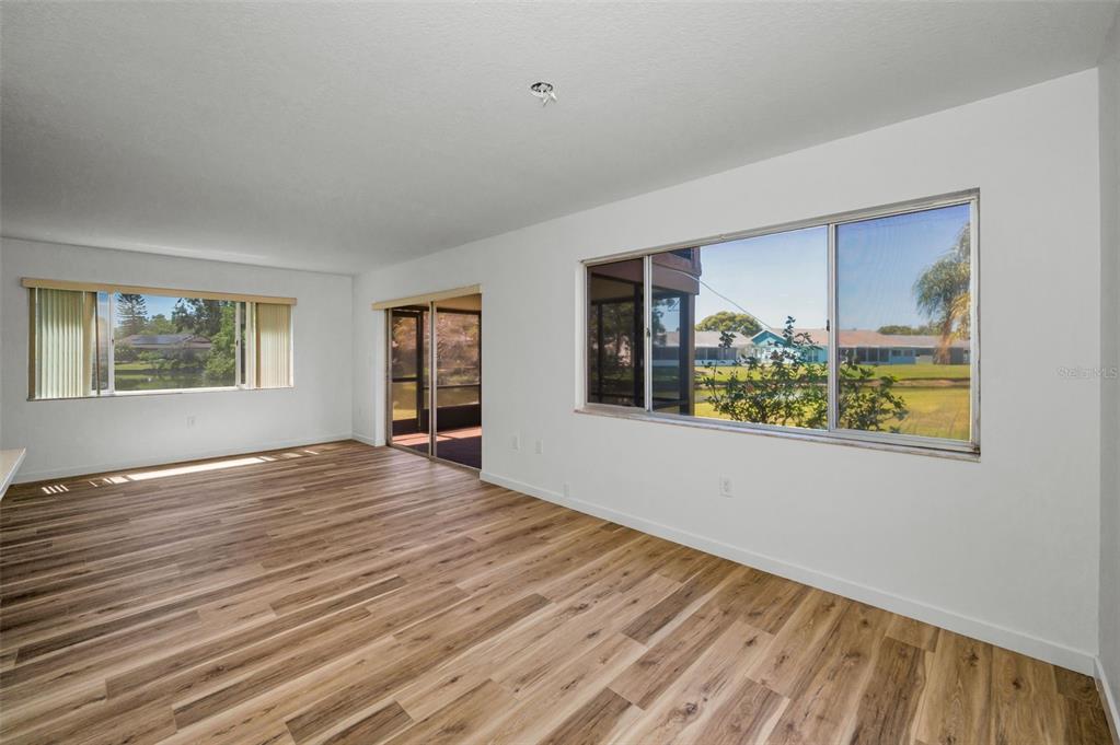 3847 Lighthouse Way, Unit 3847 New Port Richey, FL 34652 - Photo 20 of 89 a view of an empty room with window and wooden floor