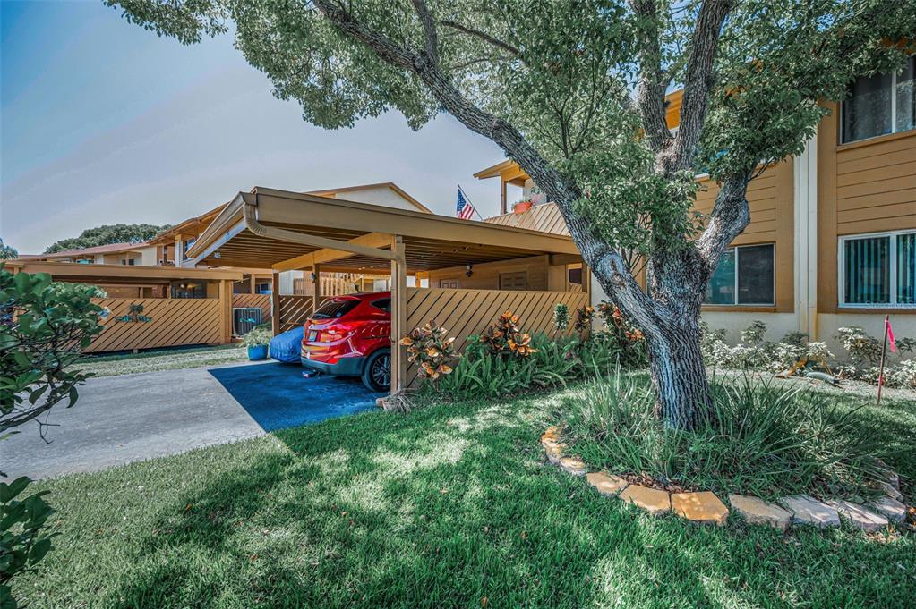3847 Lighthouse Way, Unit 3847 New Port Richey, FL 34652 - Photo 2 of 89 a front view of a house with garden
