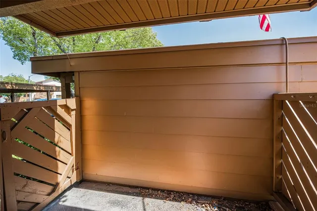 a view of a house with a big yard and large trees