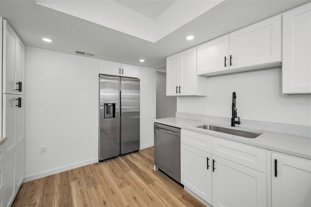 3847 Lighthouse Way, Unit 3847 New Port Richey, FL 34652 - Photo 30 of 89 a kitchen with a sink stainless steel appliances and cabinets