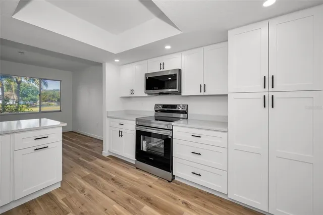 a view of a lake with houses in the background