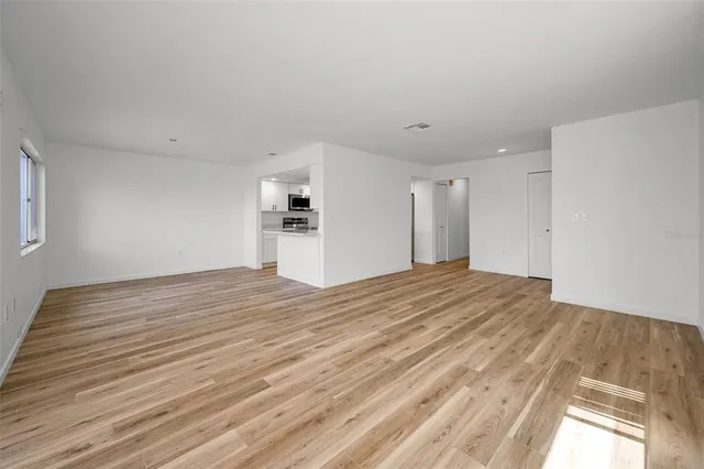 a room with gym equipment and large windows