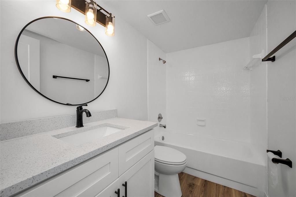 3847 Lighthouse Way, Unit 3847 New Port Richey, FL 34652 - Photo 42 of 89 a bathroom with a sink a mirror and a toilet