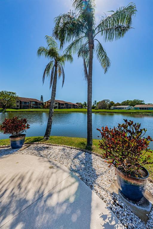 3847 Lighthouse Way, Unit 3847 New Port Richey, FL 34652 - Photo 59 of 89 a view of a lake with a table and a chair