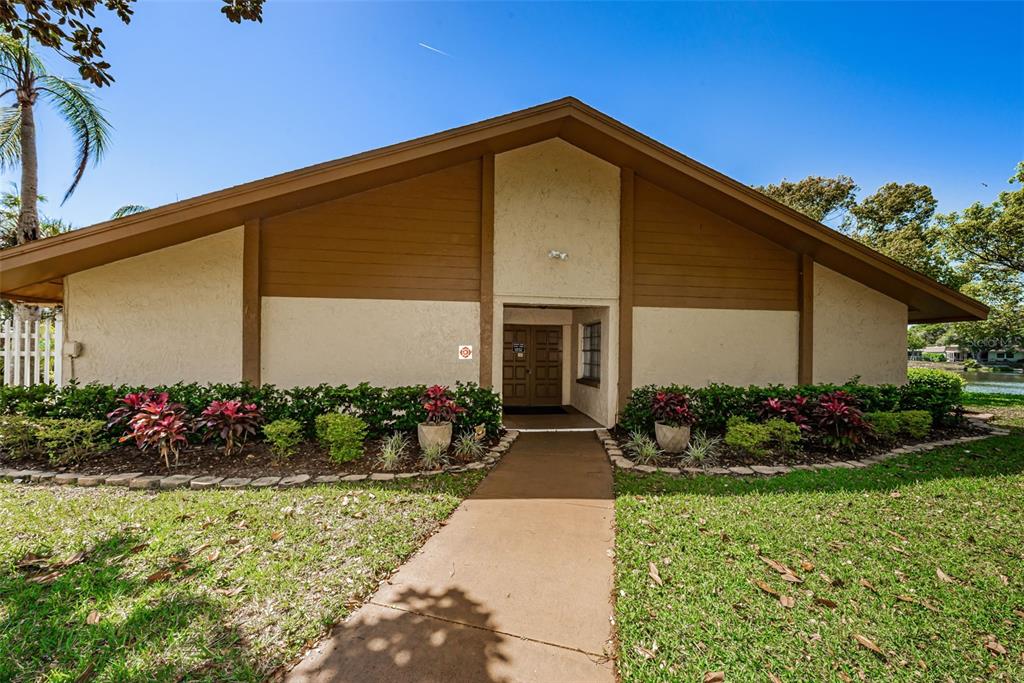 3847 Lighthouse Way, Unit 3847 New Port Richey, FL 34652 - Photo 77 of 89 a front view of a house with a garden