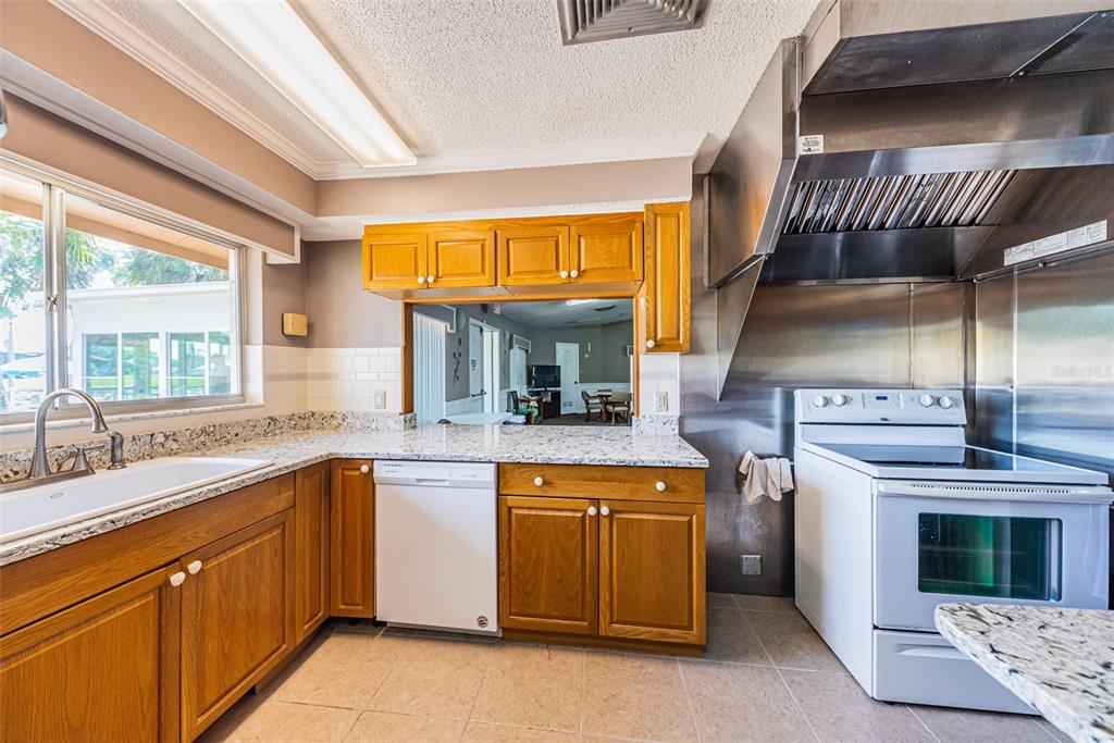 3847 Lighthouse Way, Unit 3847 New Port Richey, FL 34652 - Photo 80 of 89 a kitchen with a stove and a sink