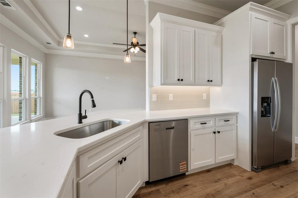 507 Limestone Circle Mabank, TX 75147 - Photo 14 of 36 a kitchen with stainless steel appliances granite countertop a refrigerator and a sink