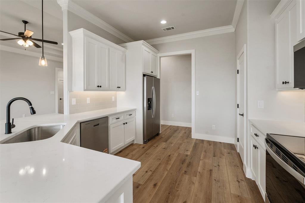 507 Limestone Circle Mabank, TX 75147 - Photo 16 of 36 a kitchen with sink a refrigerator and cabinets