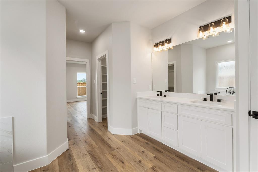 507 Limestone Circle Mabank, TX 75147 - Photo 19 of 36 a bathroom with a double vanity sink a mirror and a shower