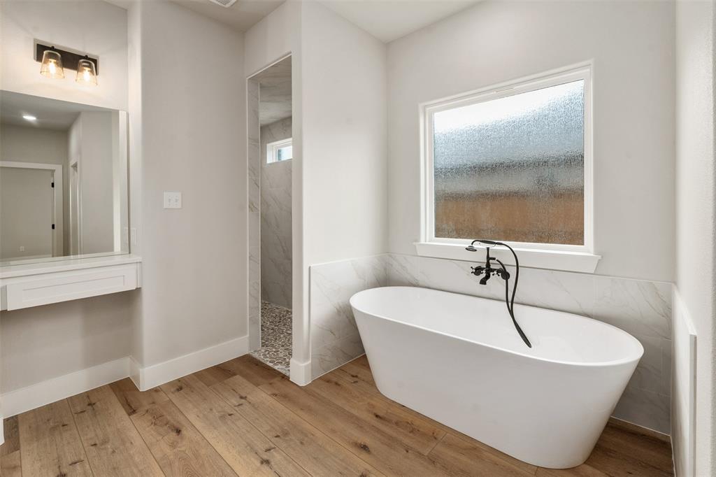 507 Limestone Circle Mabank, TX 75147 - Photo 21 of 36 a white bath tub sitting in a bathroom