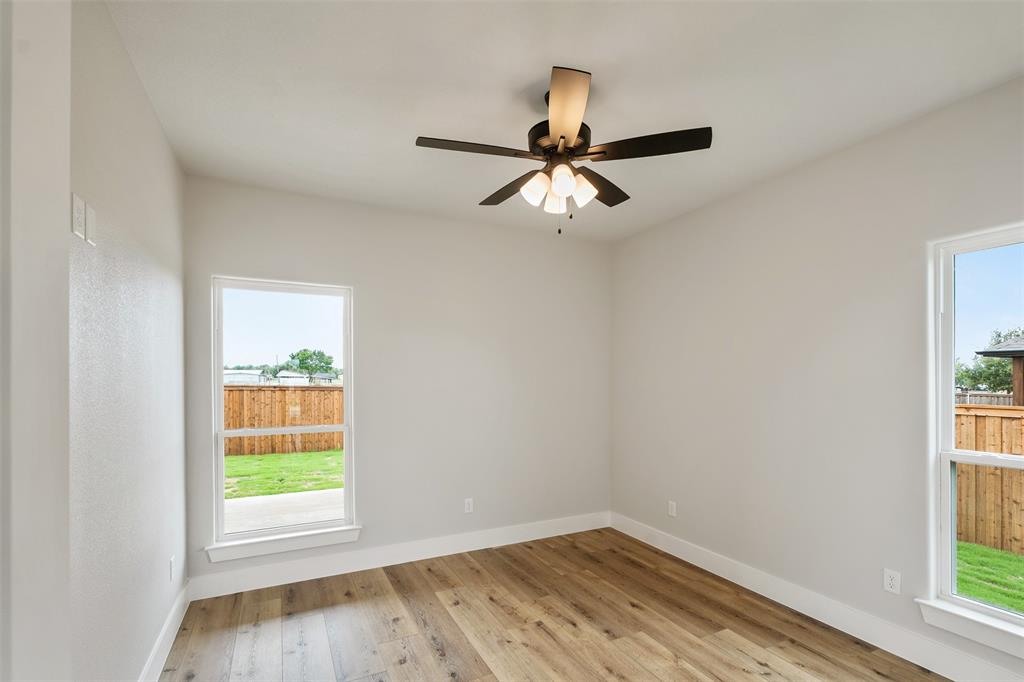 507 Limestone Circle Mabank, TX 75147 - Photo 23 of 36 a view of empty room with wooden floor and fan