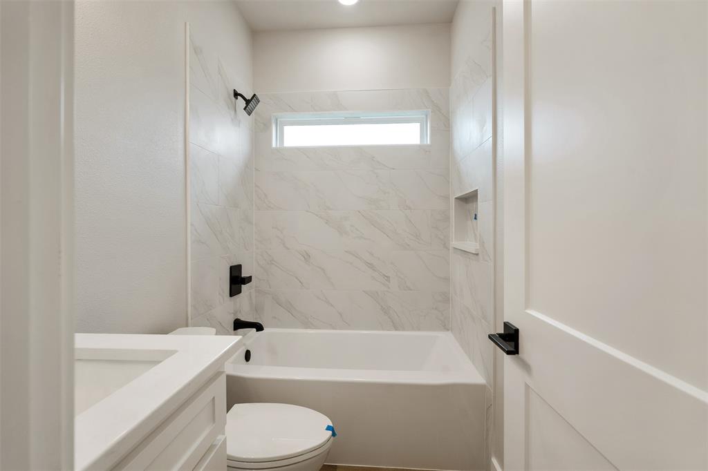 507 Limestone Circle Mabank, TX 75147 - Photo 25 of 36 a bathroom with a bathtub shower sink vanity and toilet