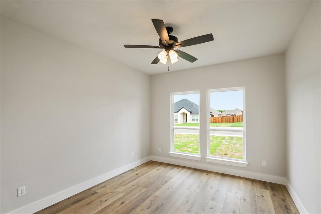 507 Limestone Circle Mabank, TX 75147 - Photo 26 of 36 an empty room with window and ceiling fan