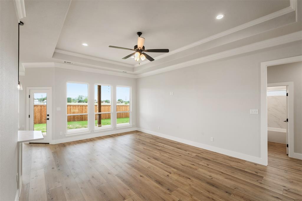 507 Limestone Circle Mabank, TX 75147 - Photo 5 of 36 a view of an empty room with wooden floor and a window