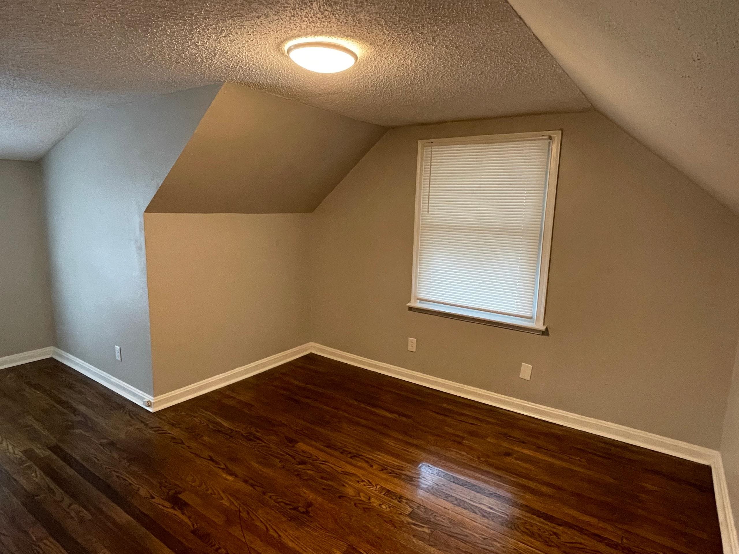984 East Raines Road Memphis, TN 38116 - Photo 12 of 19 an empty room with wooden floor and windows