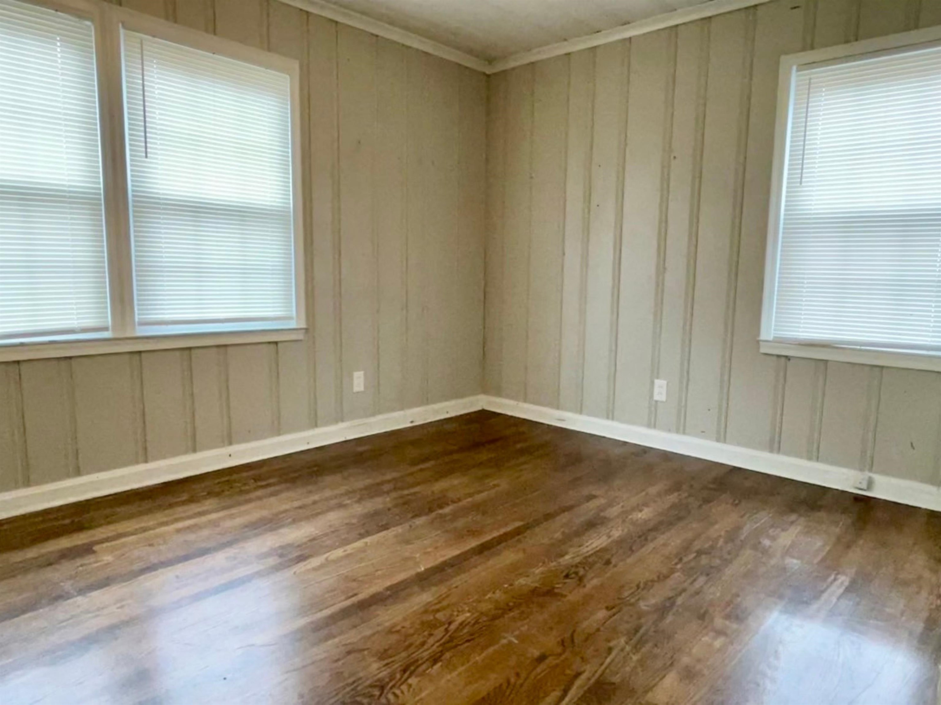 984 East Raines Road Memphis, TN 38116 - Photo 6 of 19 a view of an empty room with wooden floor and a window