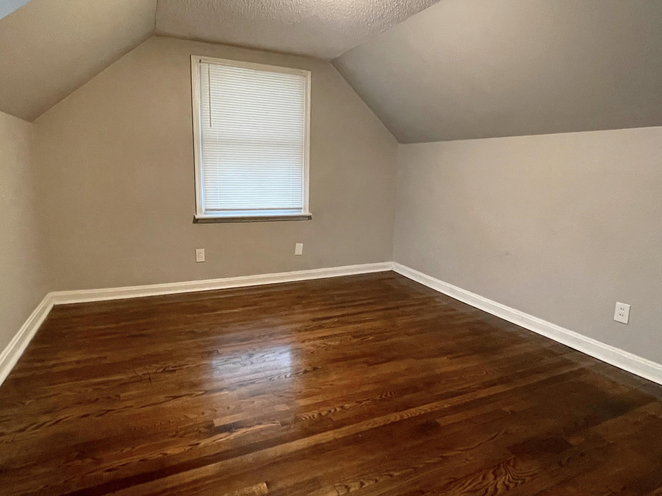 984 East Raines Road Memphis, TN 38116 - Photo 9 of 19 a view of empty room with wooden floor and fan