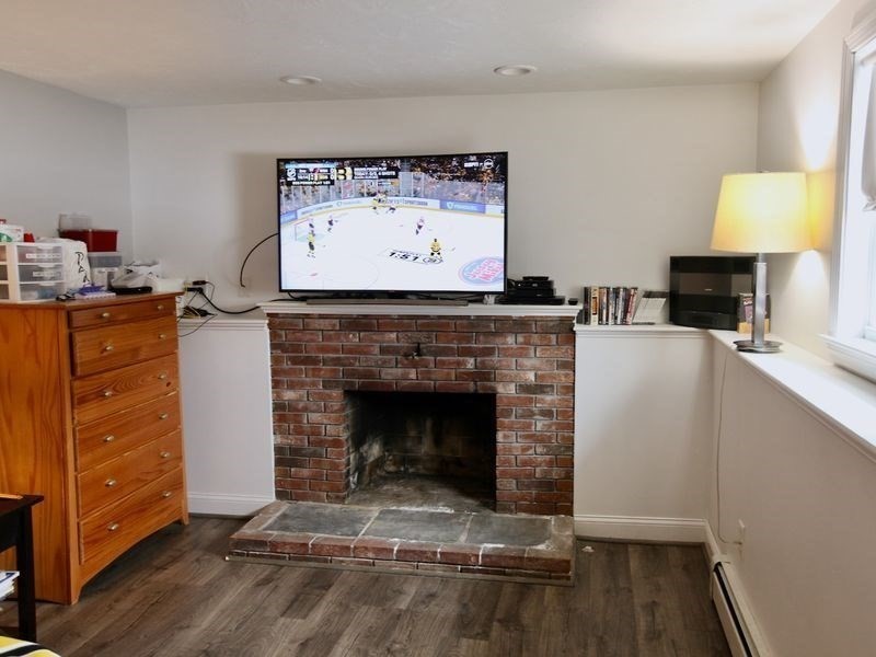 54 Ann Street Raynham, MA 02767 - Photo 16 of 21 a living room with furniture and a fireplace