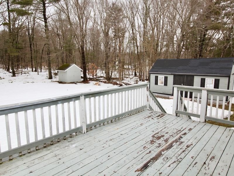 54 Ann Street Raynham, MA 02767 - Photo 19 of 21 a view of a wooden deck and a yard with wooden fence