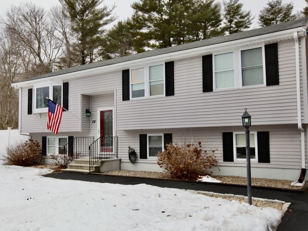 54 Ann Street Raynham, MA 02767 - Photo 2 of 21 a front view of a house with a yard and garage