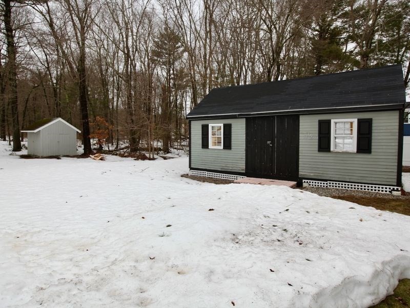 54 Ann Street Raynham, MA 02767 - Photo 21 of 21 a front view of a house with a yard covered in snow